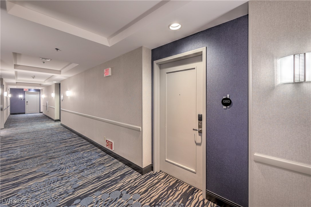 211 East Flamingo Road, Unit 1503 Las Vegas, NV 89169 - Photo 41 of 44 Hall featuring dark colored carpet, a raised ceiling, and a textured wall