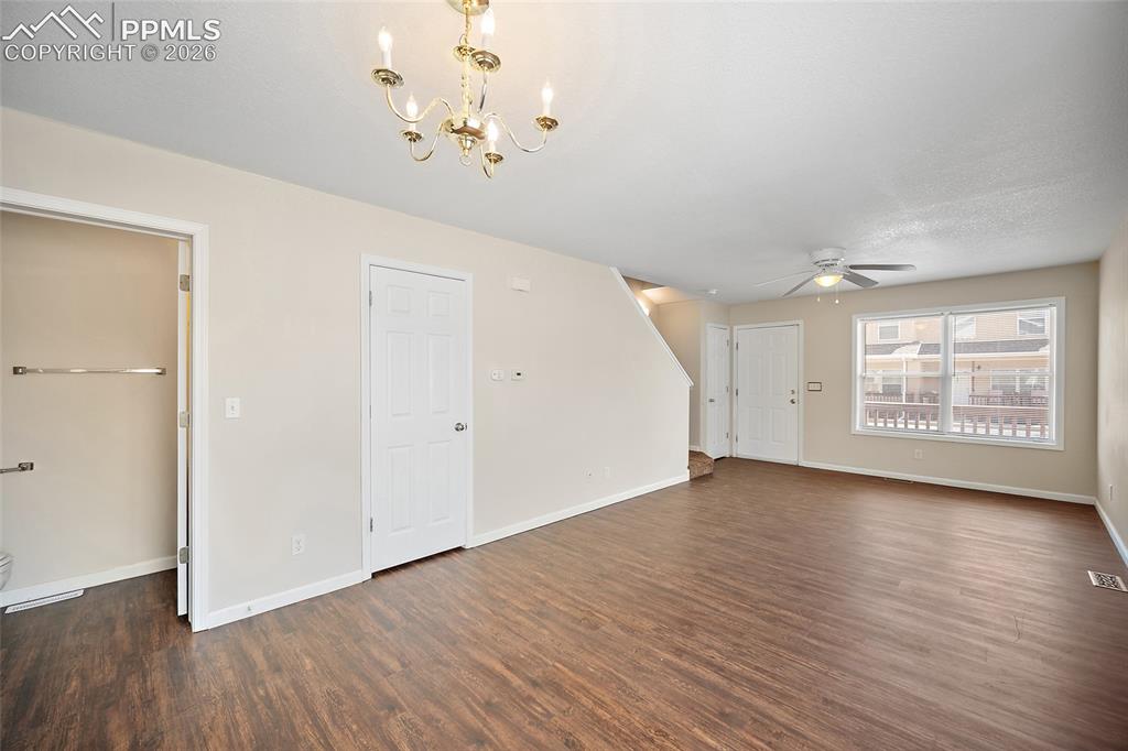 4400 Rawhide Road, Unit 157 Pueblo, CO 81008 - Photo 11 of 36 an empty room with wooden floor and windows