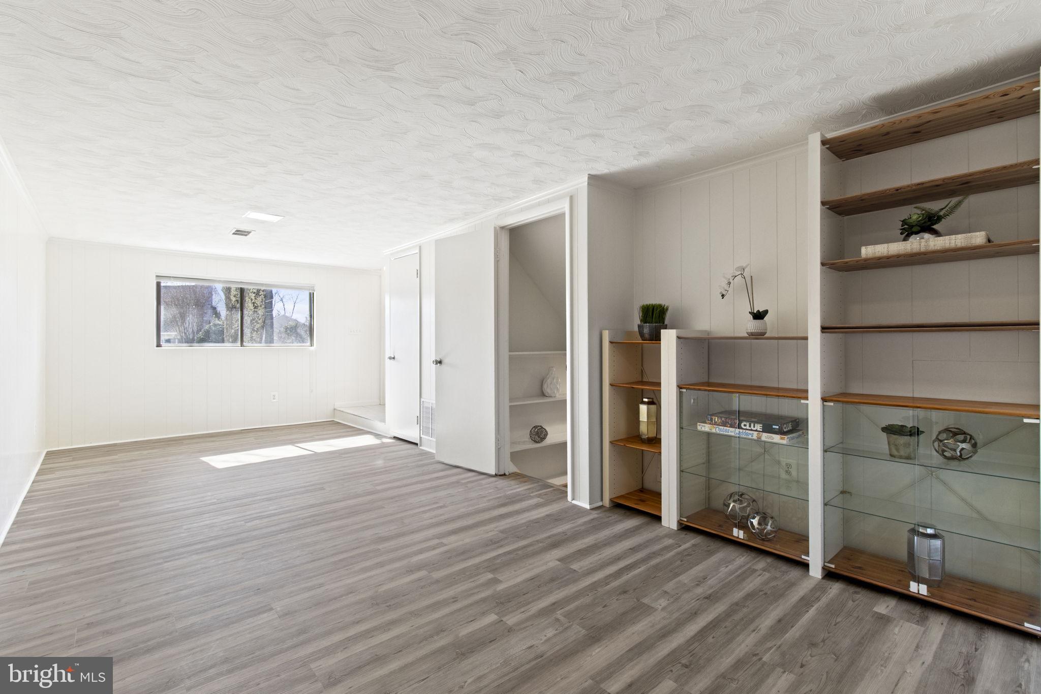 9703 Singleton Drive Bethesda, MD 20817 - Photo 17 of 22 a view of a kitchen with wooden floor and cabinets