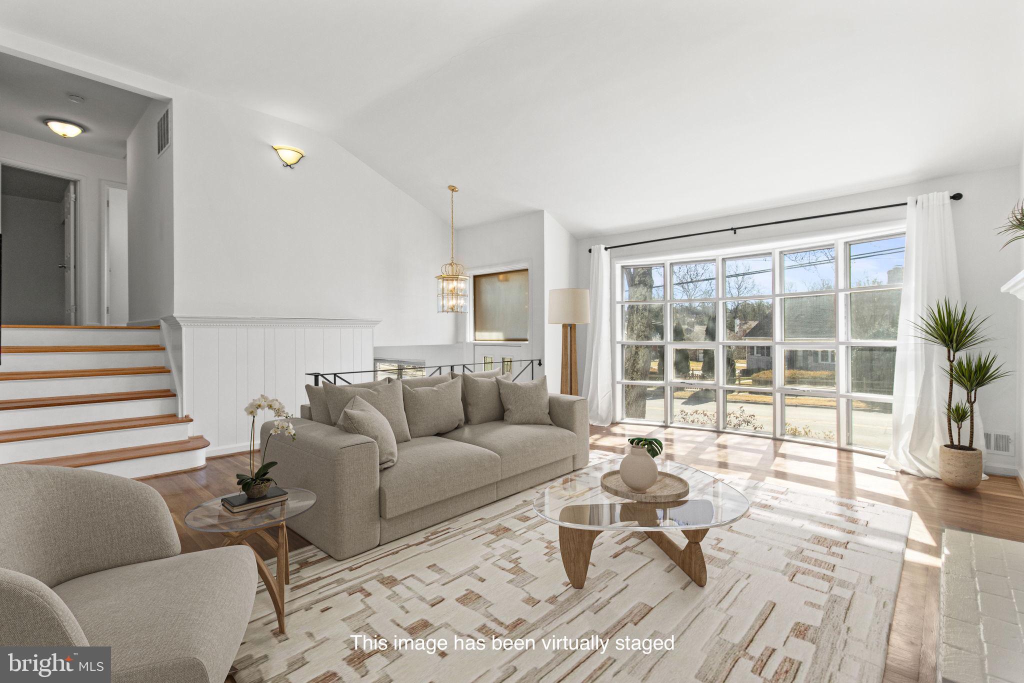 9703 Singleton Drive Bethesda, MD 20817 - Photo 2 of 22 a living room with furniture and a large window