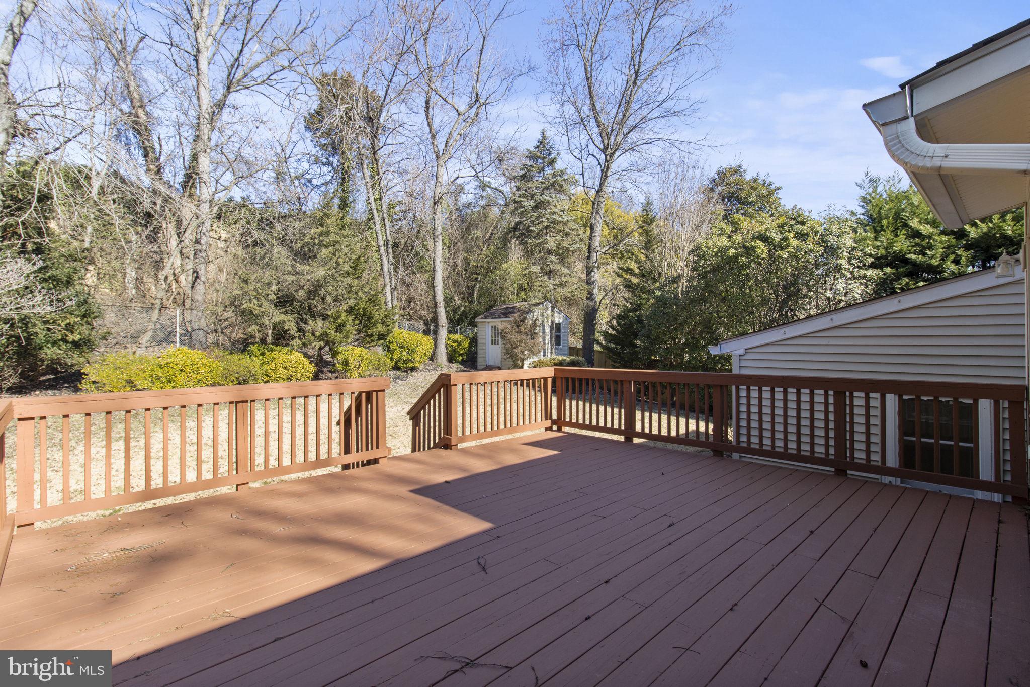 9703 Singleton Drive Bethesda, MD 20817 - Photo 9 of 22 a balcony with wooden floor and fence