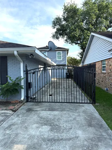 a view of a house with wooden fence