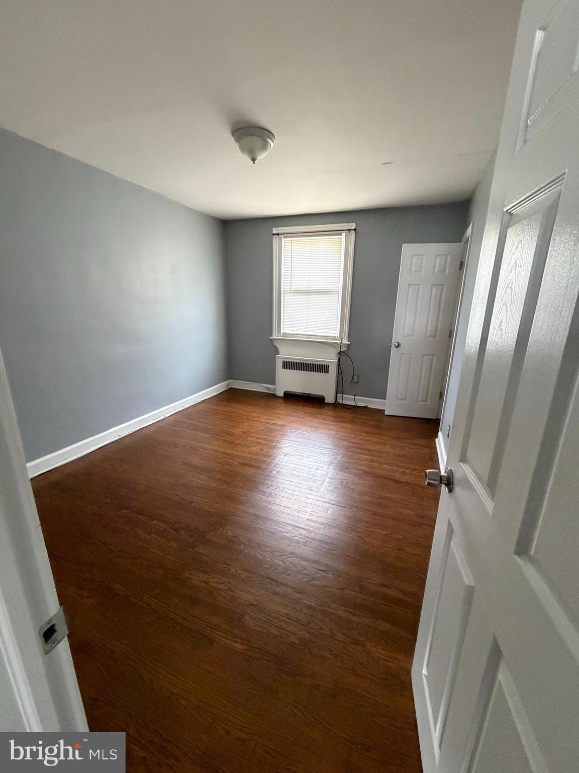 6404 Marsden Street Philadelphia, PA 19135 - Photo 3 of 8 wooden floor in an empty room with a window