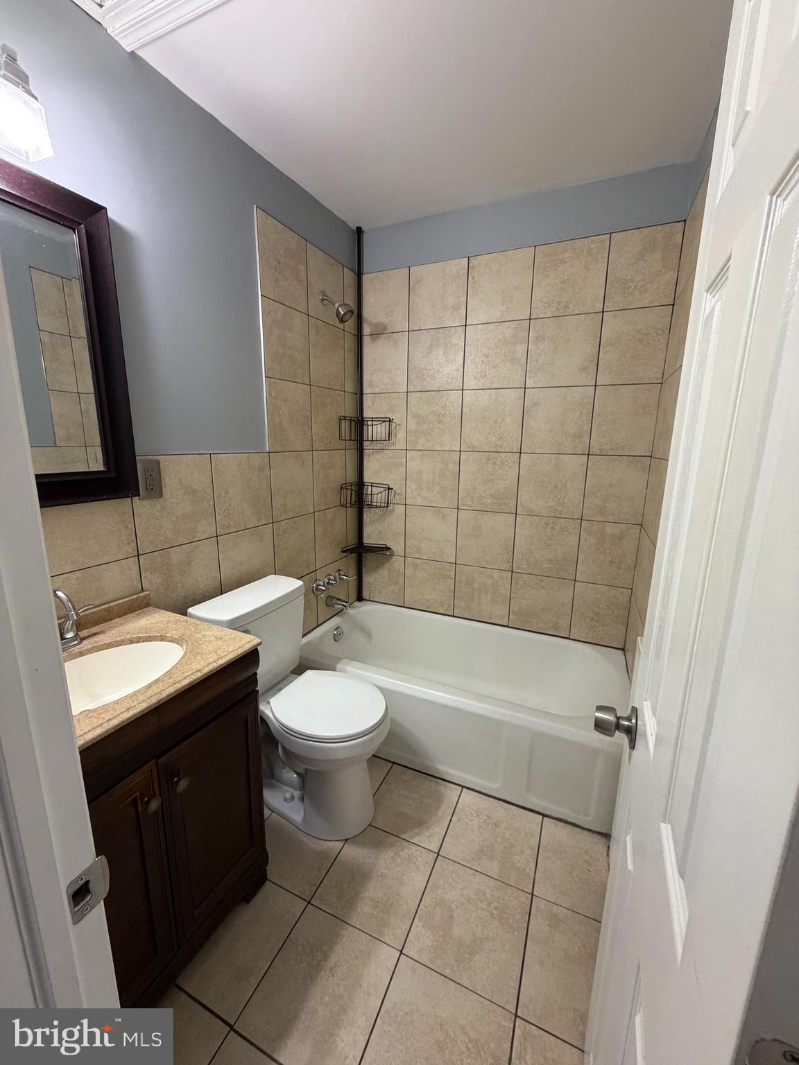6404 Marsden Street Philadelphia, PA 19135 - Photo 4 of 8 a bathroom with a sink a toilet and shower