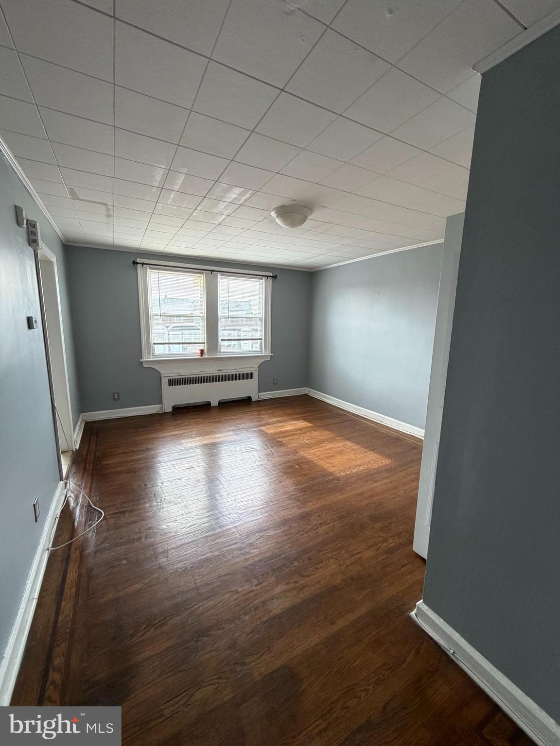6404 Marsden Street Philadelphia, PA 19135 - Photo 5 of 8 an empty room with wooden floor and windows