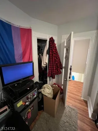 a view of sitting area with furniture and wooden floor