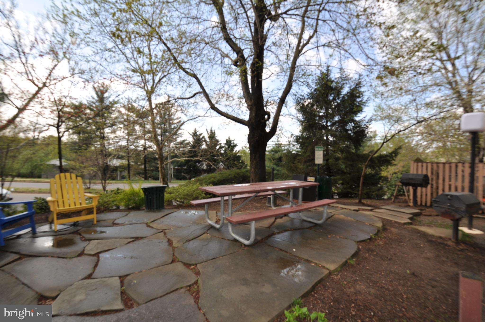 5911 Edsall Road, Unit 403 Alexandria, VA 22304 - Photo 24 of 29 a view of a patio with table and chairs under an umbrella