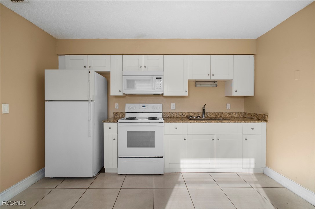 5539 Tenth Avenue Fort Myers, FL 33907 - Photo 11 of 20 a white refrigerator freezer sitting inside of a kitchen
