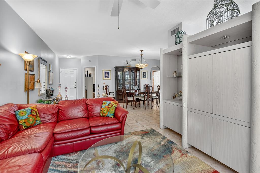 12614 Tiboli Chase Court, Unit 1 Boca Raton, FL 33496 - Photo 11 of 62 a living room with furniture with kitchen appliances and a chandelier
