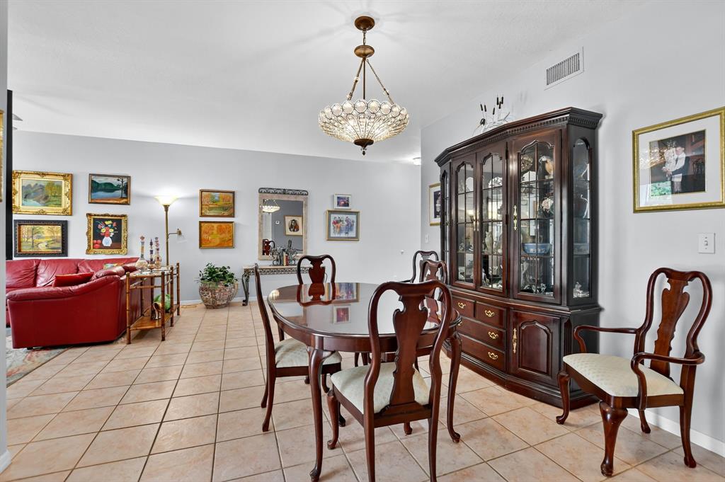 12614 Tiboli Chase Court, Unit 1 Boca Raton, FL 33496 - Photo 14 of 62 a view of a dining room with furniture window and wooden floor