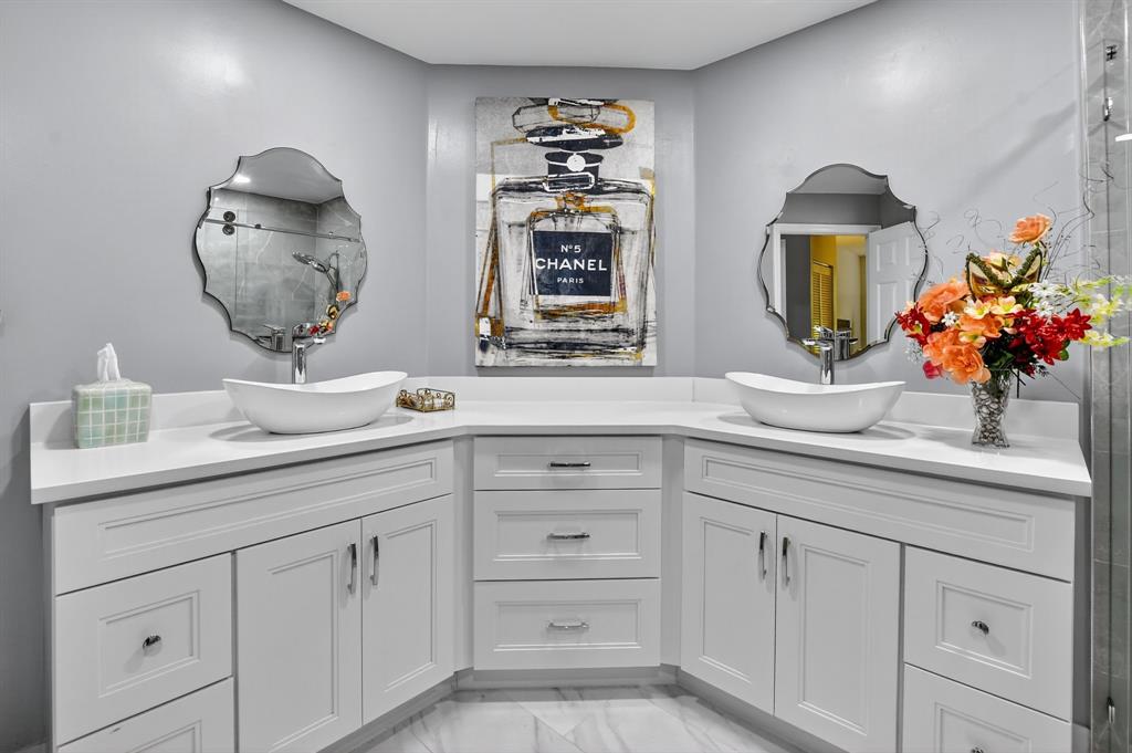 12614 Tiboli Chase Court, Unit 1 Boca Raton, FL 33496 - Photo 21 of 62 a bathroom with a sink and a mirror