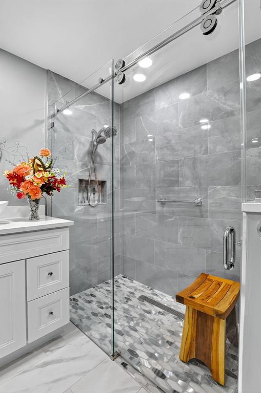 12614 Tiboli Chase Court, Unit 1 Boca Raton, FL 33496 - Photo 22 of 62 a bathroom with a shower and a sink