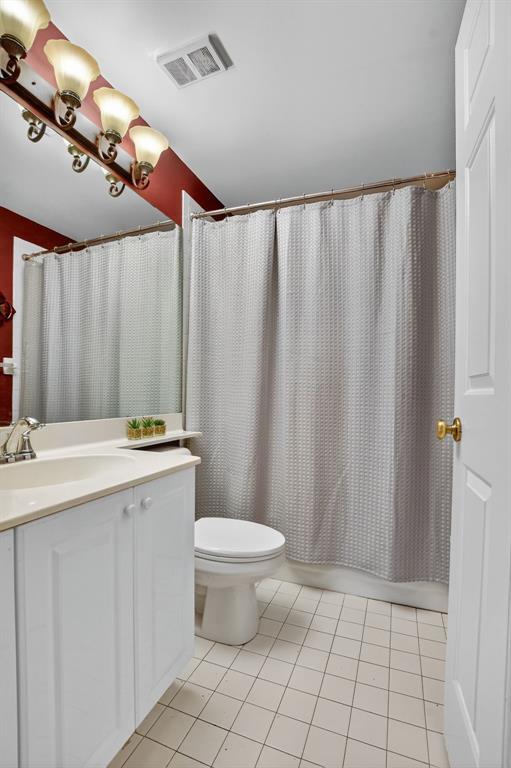 12614 Tiboli Chase Court, Unit 1 Boca Raton, FL 33496 - Photo 26 of 62 a bathroom with a sink a toilet and a mirror