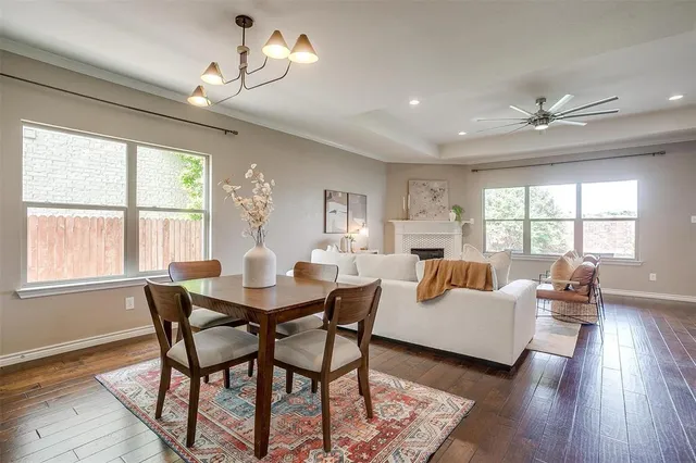 a view of a dining room with furniture a chandelier and wooden floor