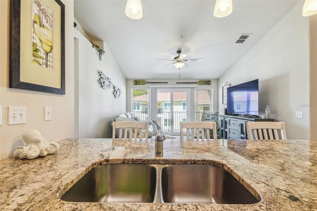 5088 Royal Palms Way, Unit 304 New Port Richey, FL 34652 - Photo 13 of 93 a kitchen with a sink and a refrigerator