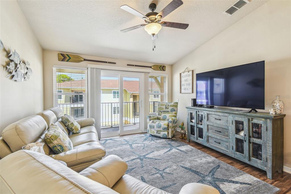 5088 Royal Palms Way, Unit 304 New Port Richey, FL 34652 - Photo 14 of 93 a living room with furniture and a flat screen tv