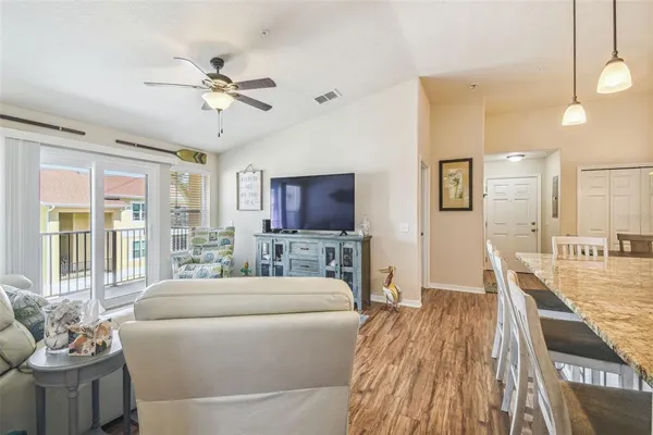 a bed room with a bed and a ceiling fan