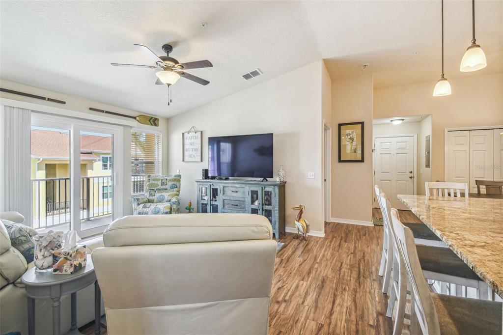 5088 Royal Palms Way, Unit 304 New Port Richey, FL 34652 - Photo 16 of 93 a living room with furniture and a flat screen tv