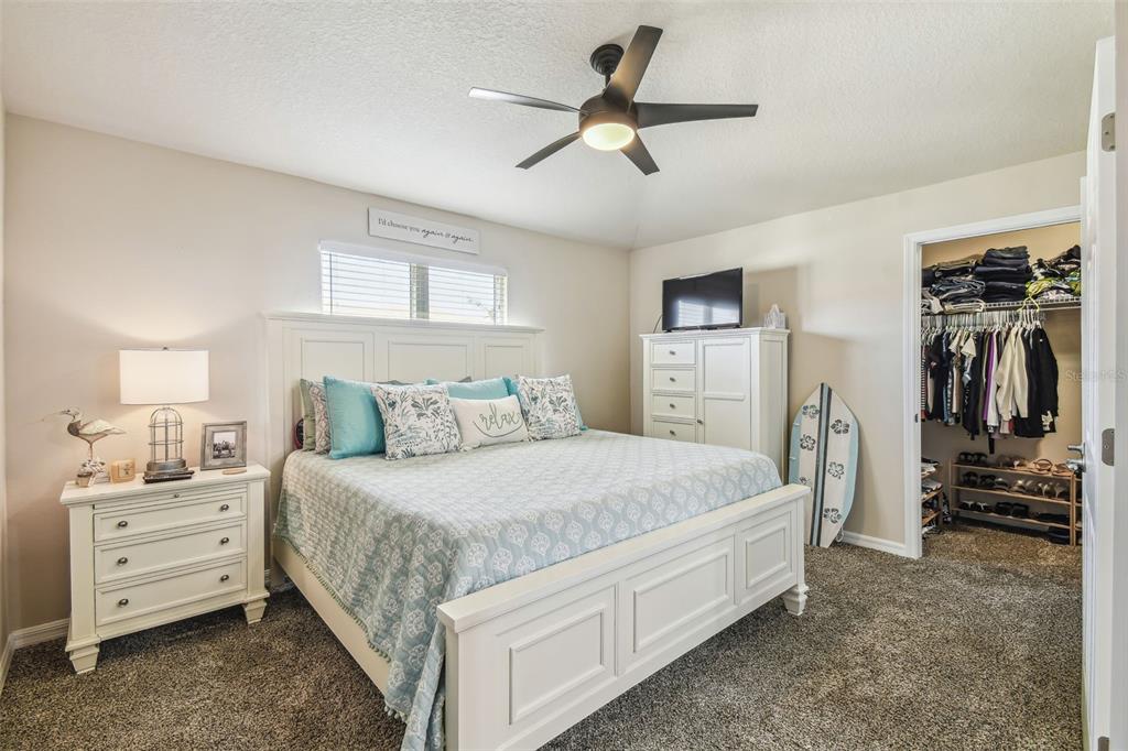 5088 Royal Palms Way, Unit 304 New Port Richey, FL 34652 - Photo 20 of 93 a bed room with a bed and a ceiling fan