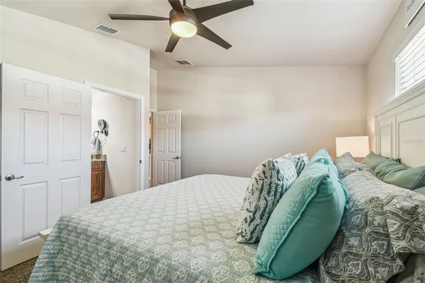 a bedroom with a bed and a window