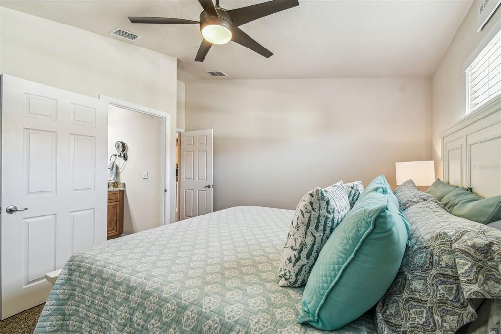 5088 Royal Palms Way, Unit 304 New Port Richey, FL 34652 - Photo 21 of 93 a bedroom with a bed and a chandelier