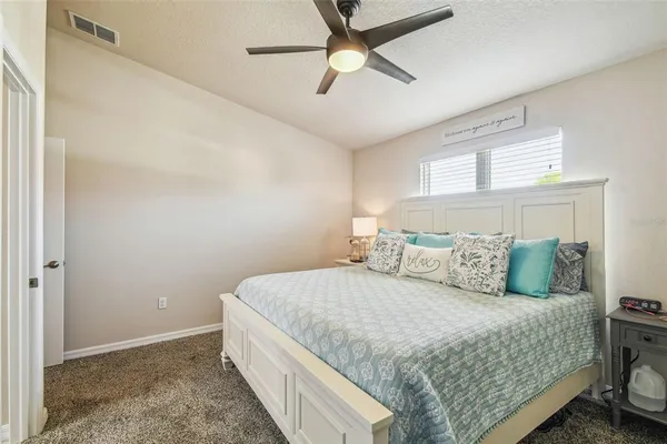 a view of a bedroom with wooden floor and a bed