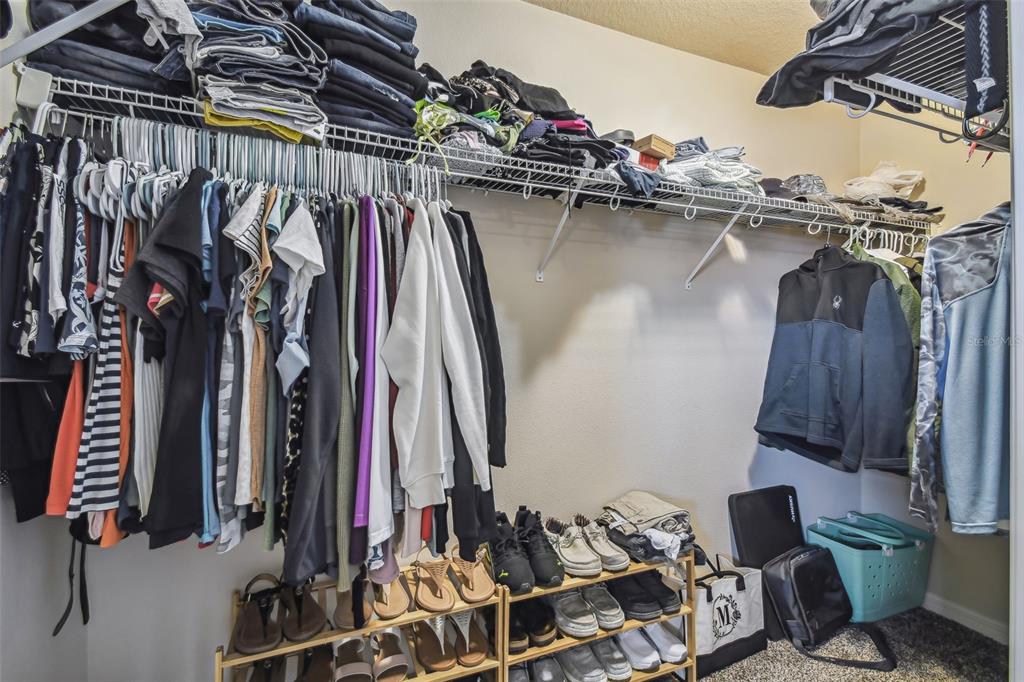 5088 Royal Palms Way, Unit 304 New Port Richey, FL 34652 - Photo 23 of 93 a view of walk in closet with clothes and shoes