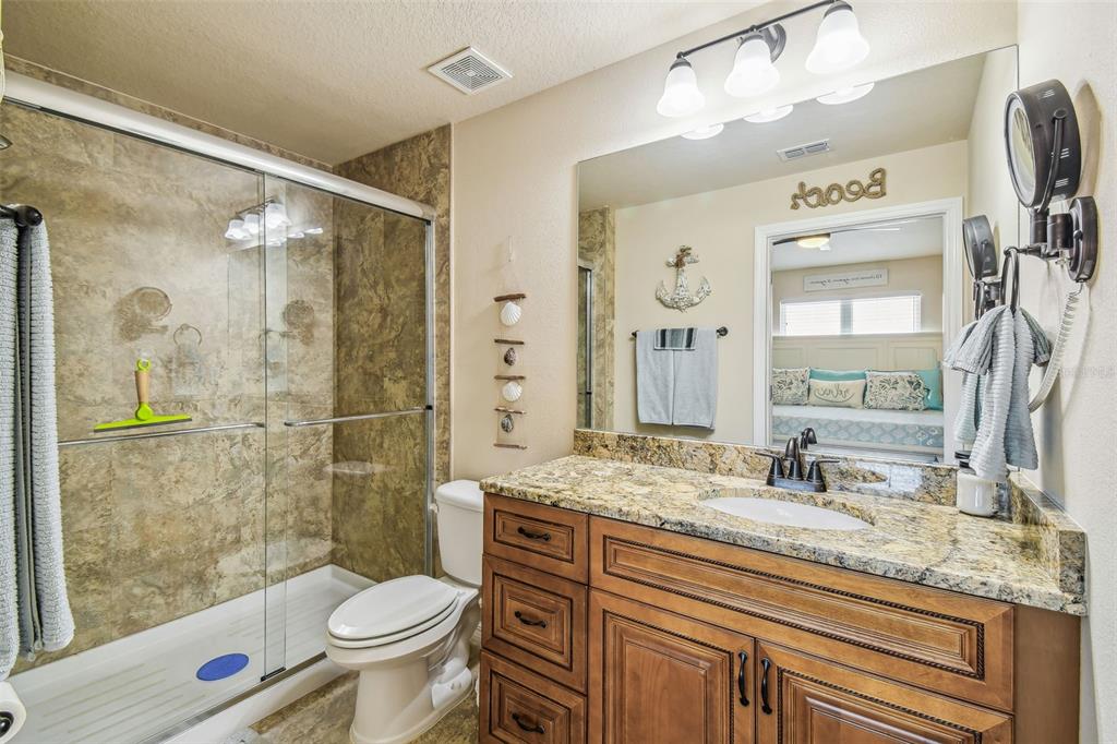 5088 Royal Palms Way, Unit 304 New Port Richey, FL 34652 - Photo 25 of 93 a bathroom with a granite countertop sink toilet and shower