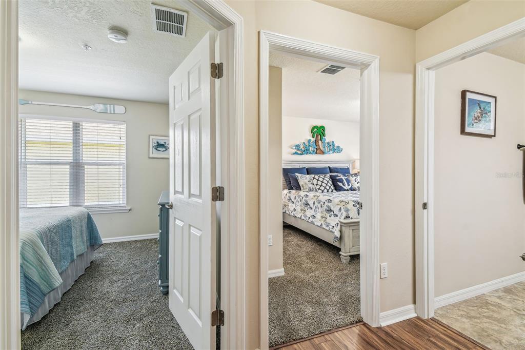 5088 Royal Palms Way, Unit 304 New Port Richey, FL 34652 - Photo 28 of 93 a view of a bedroom with wooden floor and a bed