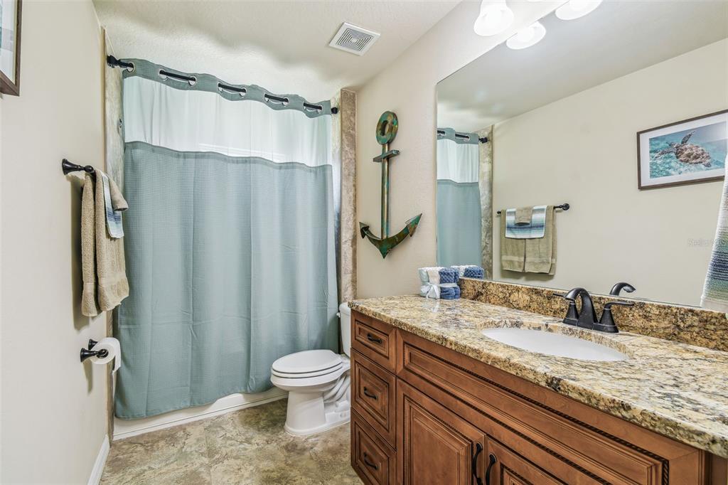5088 Royal Palms Way, Unit 304 New Port Richey, FL 34652 - Photo 31 of 93 a bathroom with a granite countertop sink toilet and shower