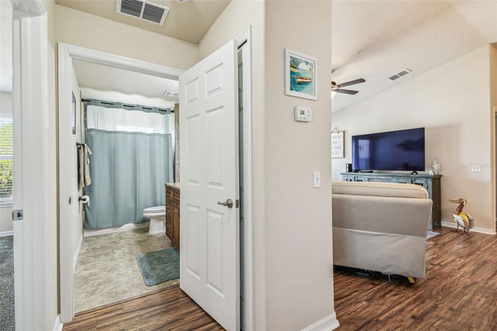 5088 Royal Palms Way, Unit 304 New Port Richey, FL 34652 - Photo 33 of 93 a view of a hallway with wooden floor and cabinet space