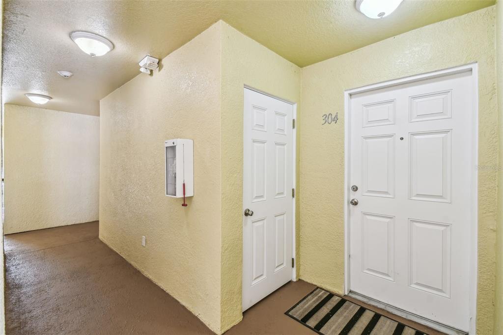 5088 Royal Palms Way, Unit 304 New Port Richey, FL 34652 - Photo 34 of 93 a view of a hallway with wooden floor