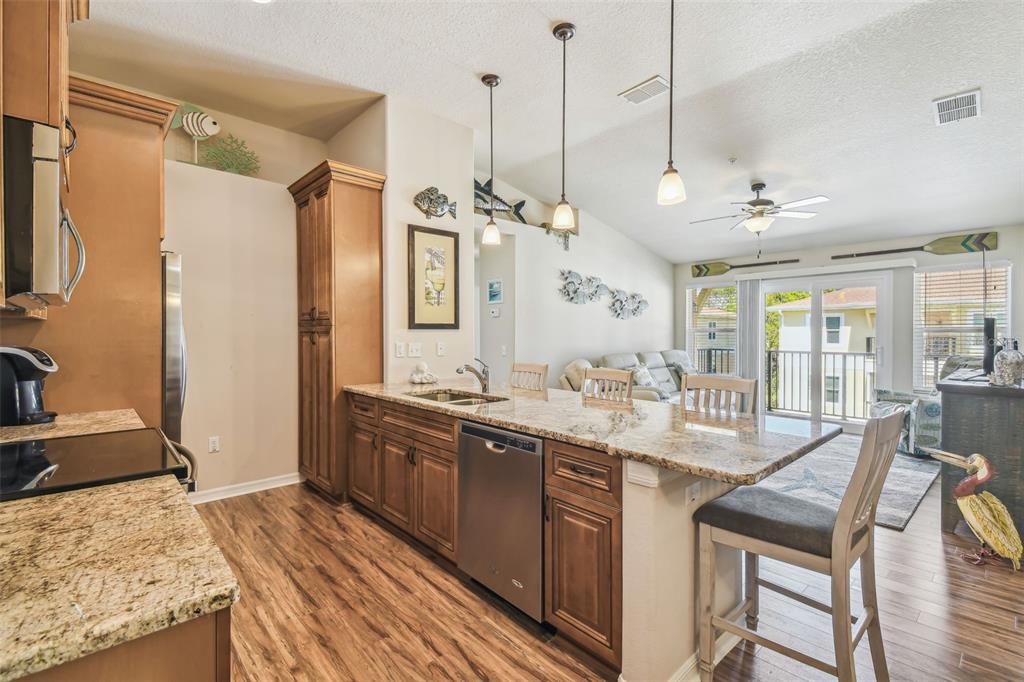 5088 Royal Palms Way, Unit 304 New Port Richey, FL 34652 - Photo 4 of 93 a kitchen with stainless steel appliances granite countertop a sink stove and refrigerator