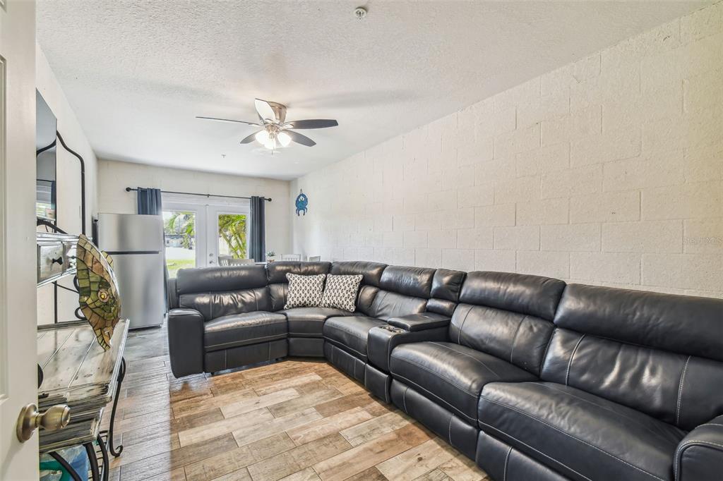 5088 Royal Palms Way, Unit 304 New Port Richey, FL 34652 - Photo 44 of 93 a living room with furniture and a chandelier