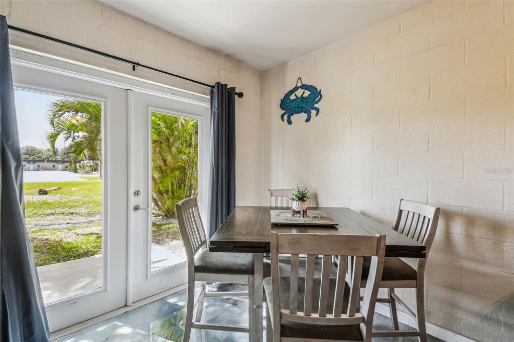 5088 Royal Palms Way, Unit 304 New Port Richey, FL 34652 - Photo 45 of 93 a view of a dining room with furniture a chandelier and wooden floor