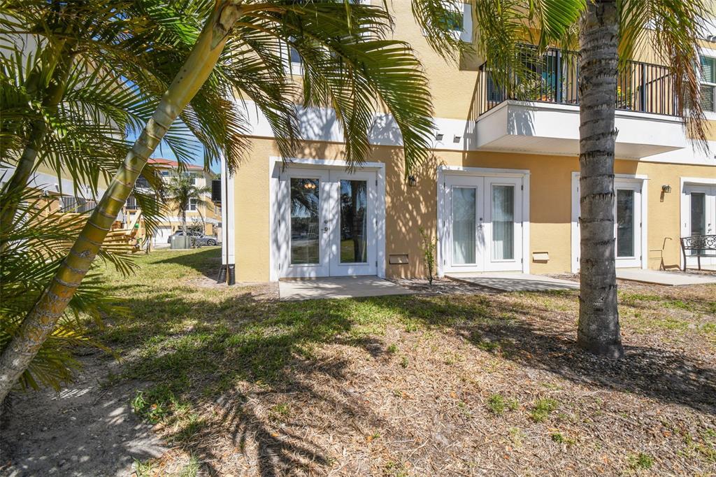 5088 Royal Palms Way, Unit 304 New Port Richey, FL 34652 - Photo 47 of 93 a view of a brick house with a large tree and windows