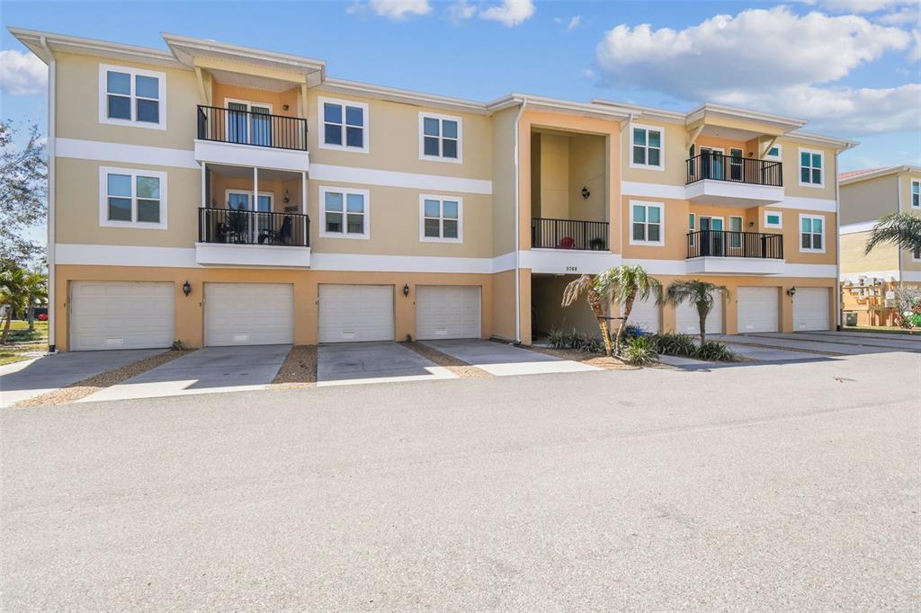 5088 Royal Palms Way, Unit 304 New Port Richey, FL 34652 - Photo 48 of 93 a front view of building with a street