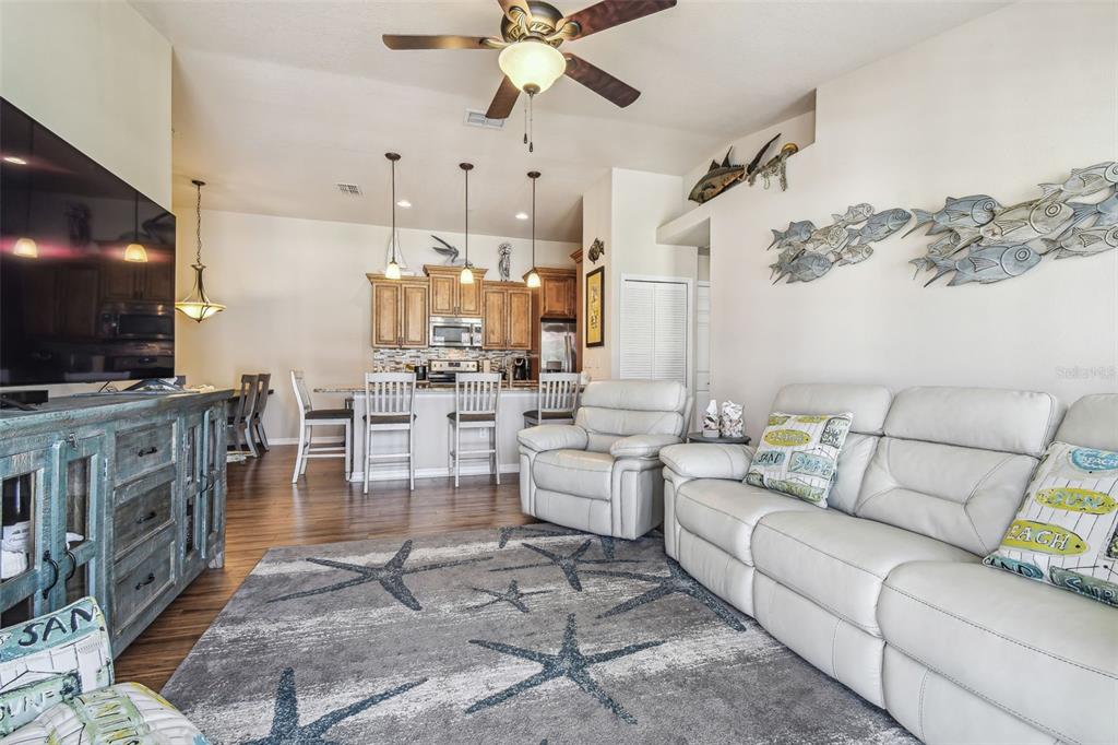 5088 Royal Palms Way, Unit 304 New Port Richey, FL 34652 - Photo 5 of 93 a living room with furniture and a flat screen tv