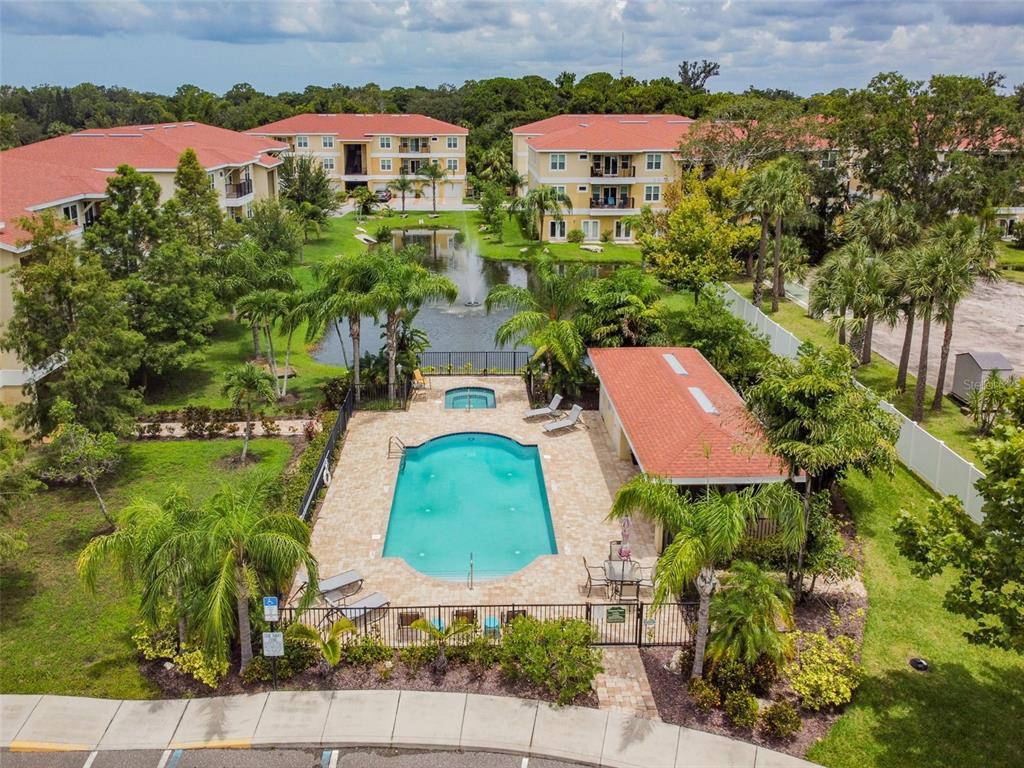 5088 Royal Palms Way, Unit 304 New Port Richey, FL 34652 - Photo 59 of 93 an aerial view of houses with yard