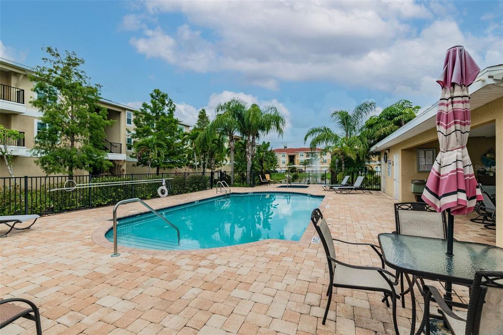 5088 Royal Palms Way, Unit 304 New Port Richey, FL 34652 - Photo 60 of 93 a view of a swimming pool with a patio