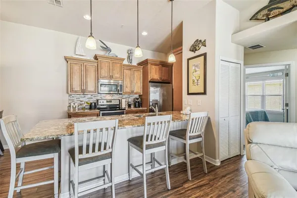 a kitchen with a sink stove and refrigerator