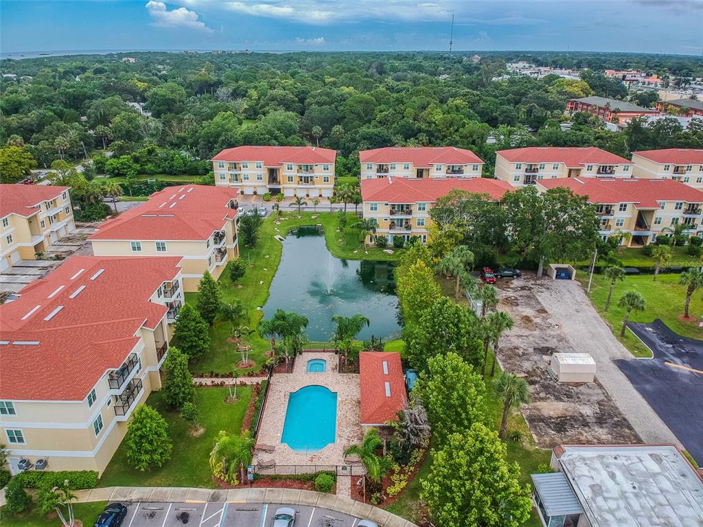 5088 Royal Palms Way, Unit 304 New Port Richey, FL 34652 - Photo 63 of 93 an aerial view of a houses with a green yard