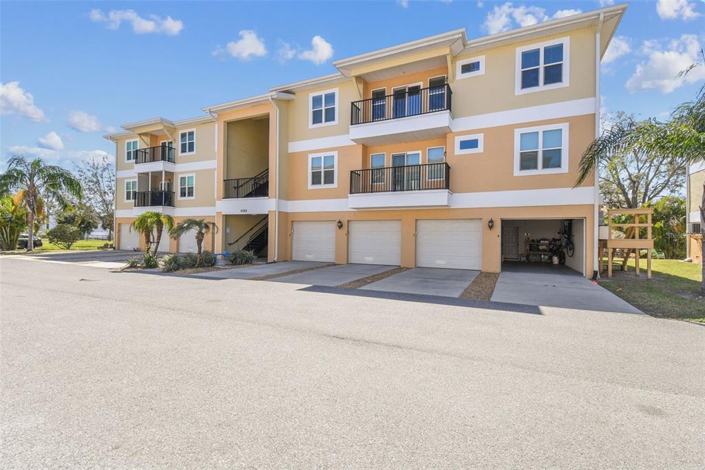 5088 Royal Palms Way, Unit 304 New Port Richey, FL 34652 - Photo 7 of 93 a front view of a building with a road and balcony