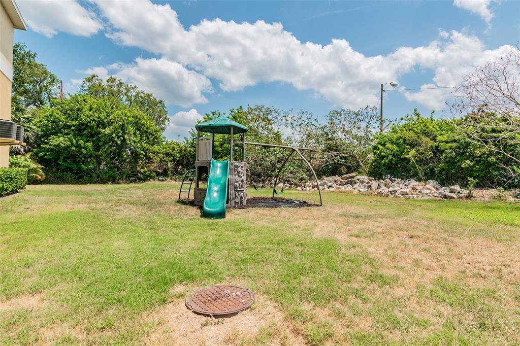 5088 Royal Palms Way, Unit 304 New Port Richey, FL 34652 - Photo 75 of 93 a view of a swimming pool with a yard