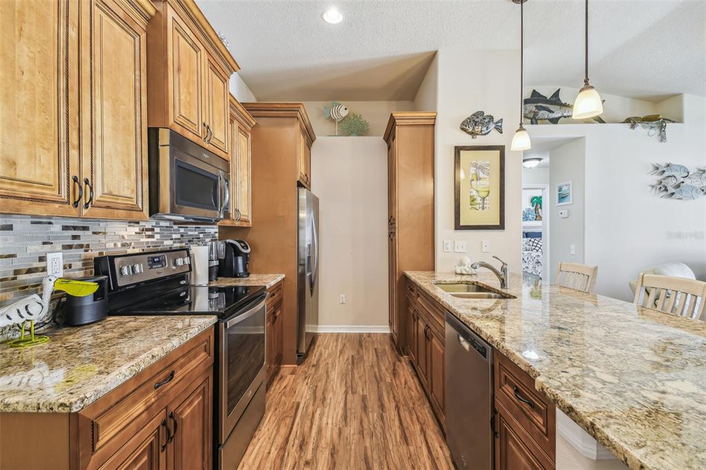 5088 Royal Palms Way, Unit 304 New Port Richey, FL 34652 - Photo 9 of 93 a kitchen with a sink stove and refrigerator