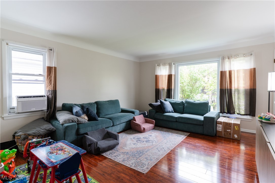 14220 Triskett Road Cleveland, OH 44111 - Photo 19 of 32 Living room featuring wood finished floors and cooling unit