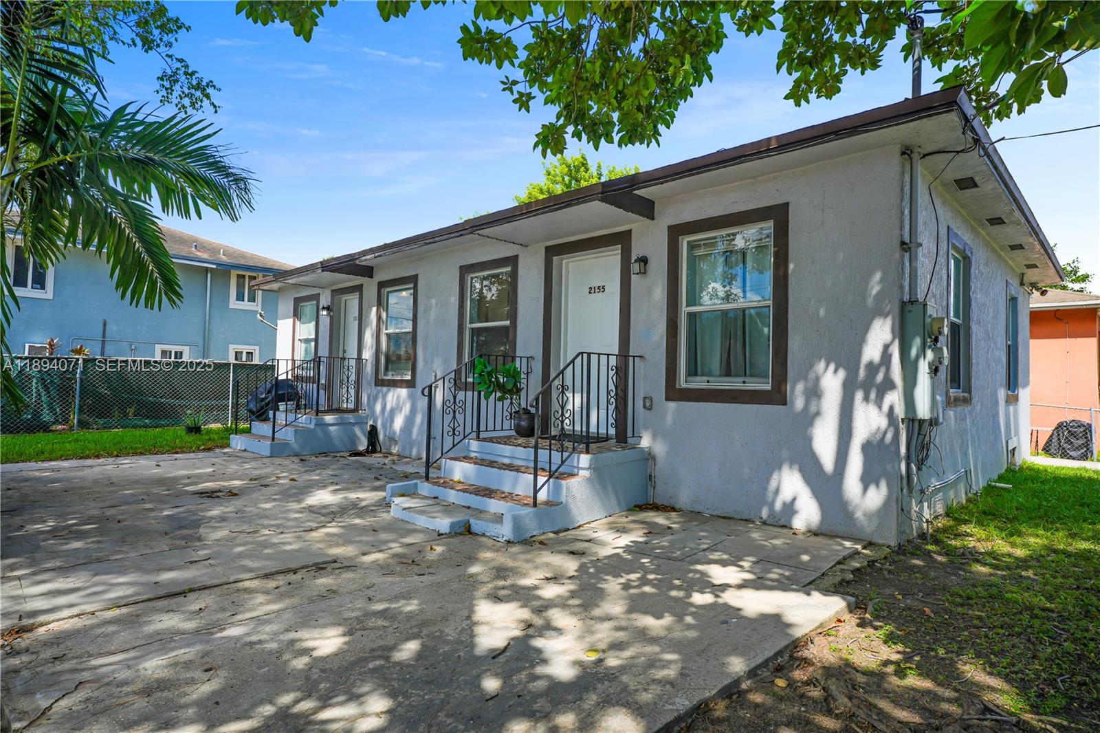 a view of a house with backyard and a tree