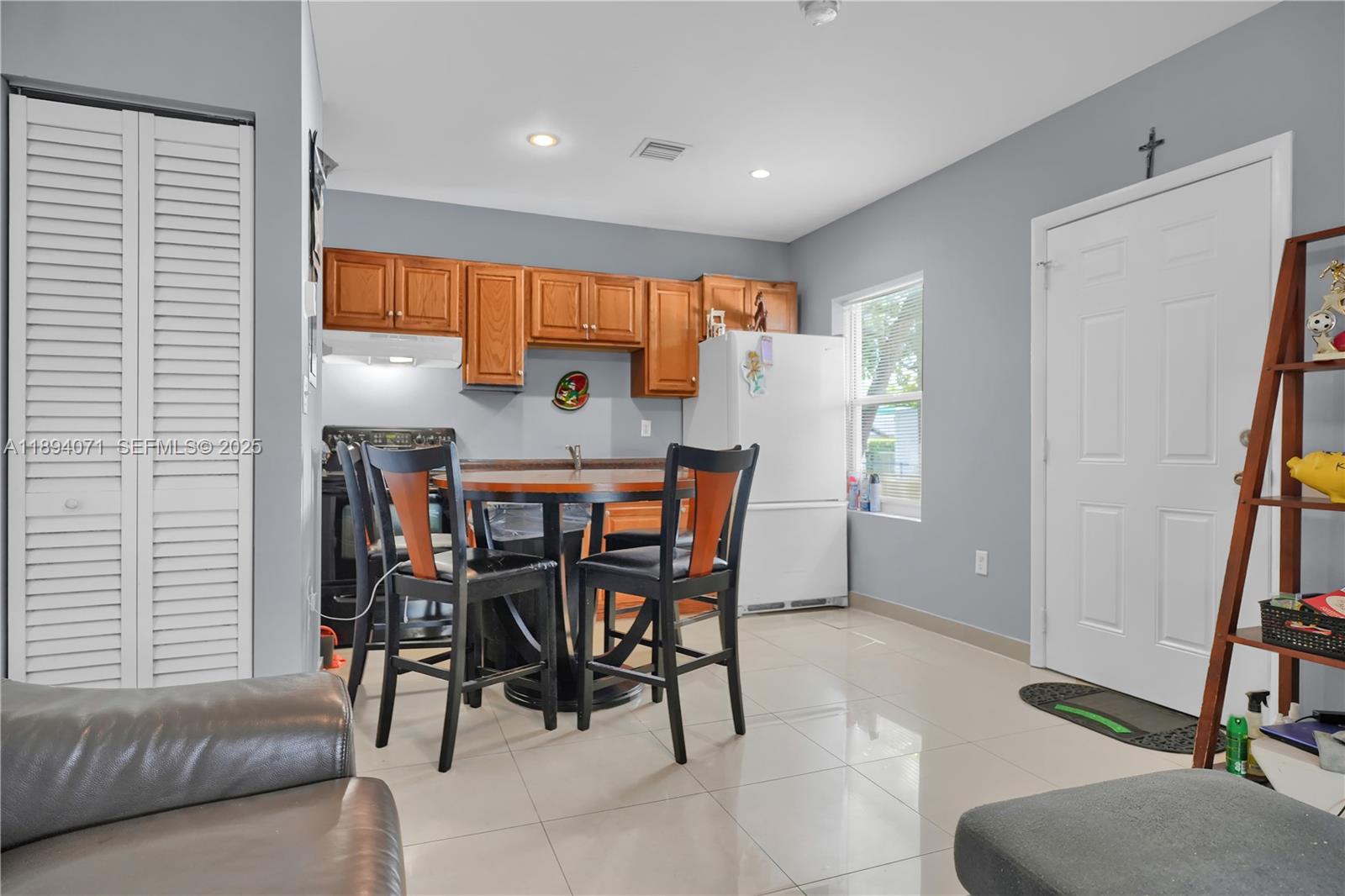 2155 Northwest 28th Street Miami, FL 33142 - Photo 11 of 18 a dining room with furniture and a window