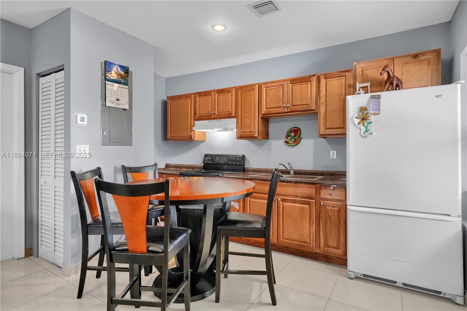 2155 Northwest 28th Street Miami, FL 33142 - Photo 13 of 18 a kitchen with stainless steel appliances granite countertop a refrigerator and a stove top oven