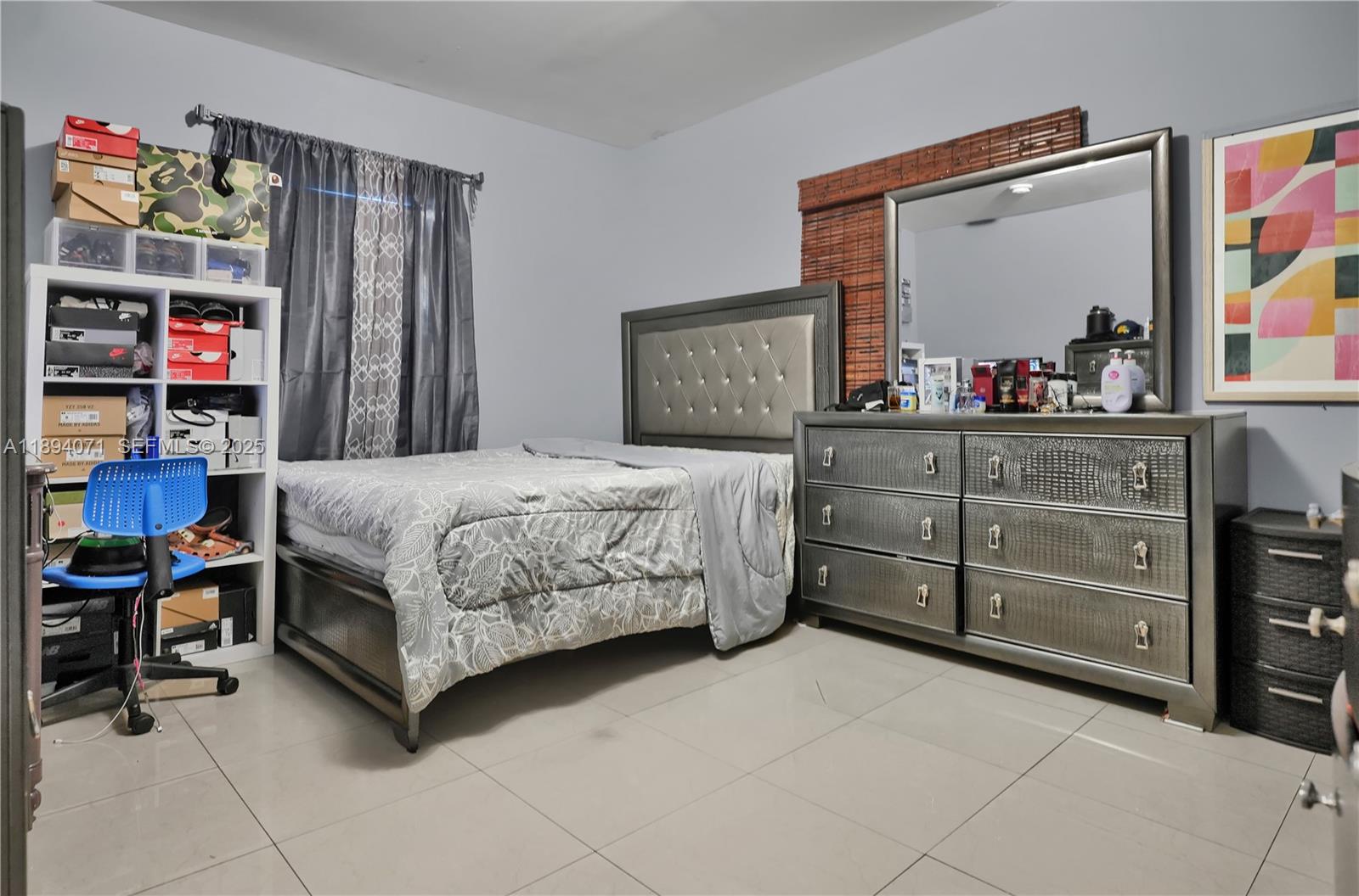 2155 Northwest 28th Street Miami, FL 33142 - Photo 14 of 18 a bedroom with a bed and a dresser